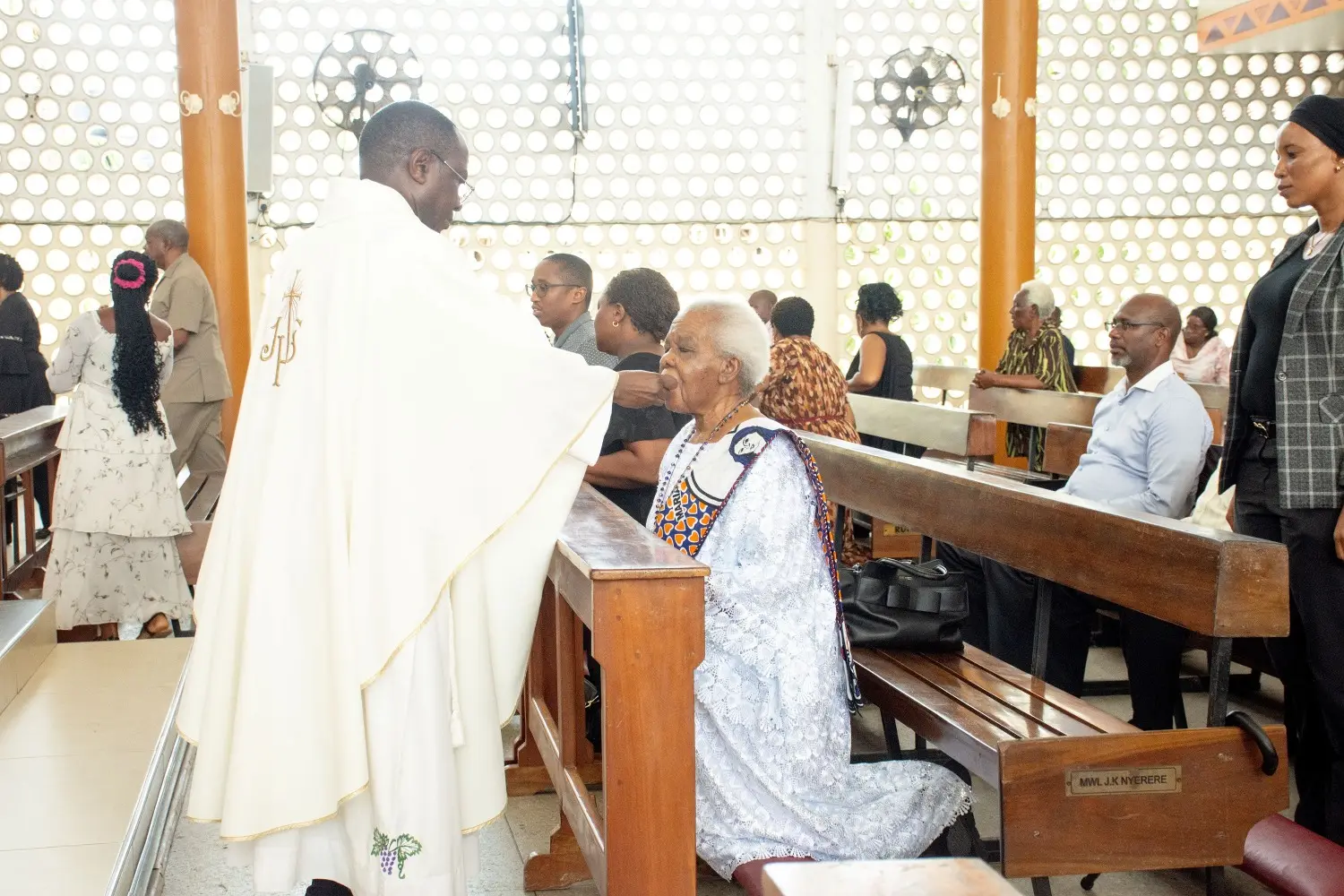 Mama Maria Nyerere receives Holy Communion during the Requiem Mass. Mama Maria Nyerere receives Holy Communion during the Requiem Mass.